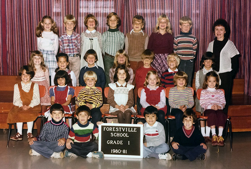 First grade class portrait from the 1980 to 1981 school year. 25 students and one teacher are shown.