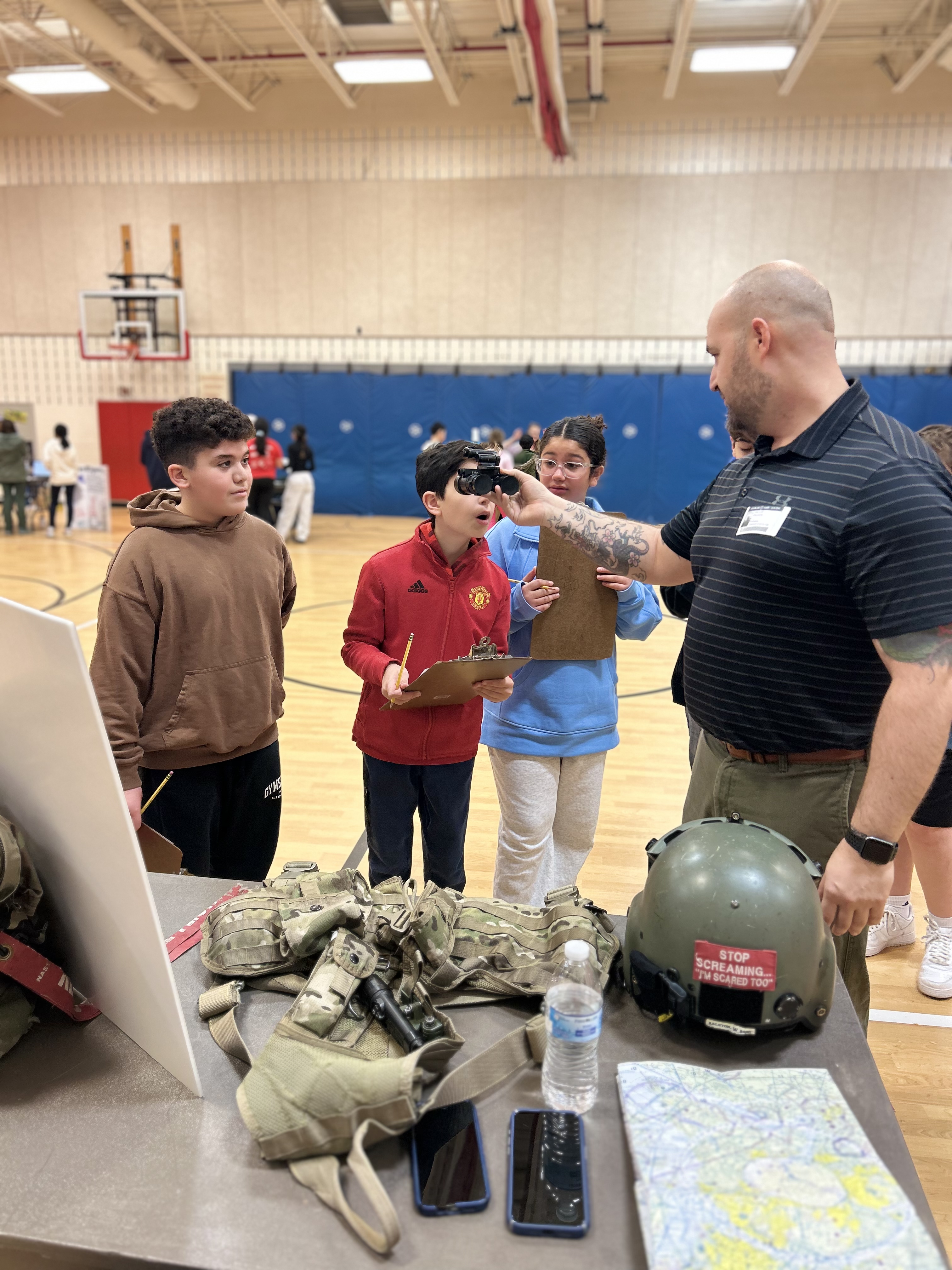 Students exploring military supplies